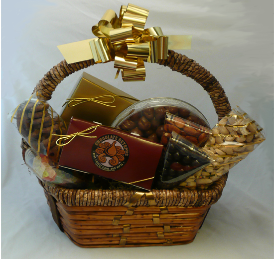 Signature Wall Basket - This traditional wall basket contains a twelve-piece assortment of our Signature Chocolates in our signature box, a large gold bag of chocolate covered pretzels with English toffee, a large round container of chocolate covered caramel corn, a four piece box of cashew octopi and three small containers filled with almonds, gummy bears and dark chocolate covered coffee beans. Shrink wrapped with a decorative bow. 